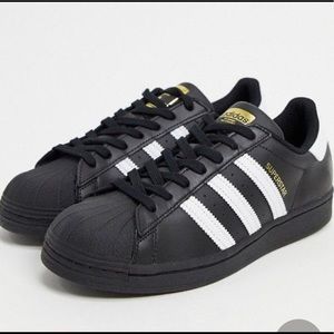 black adidas with gold shell toe